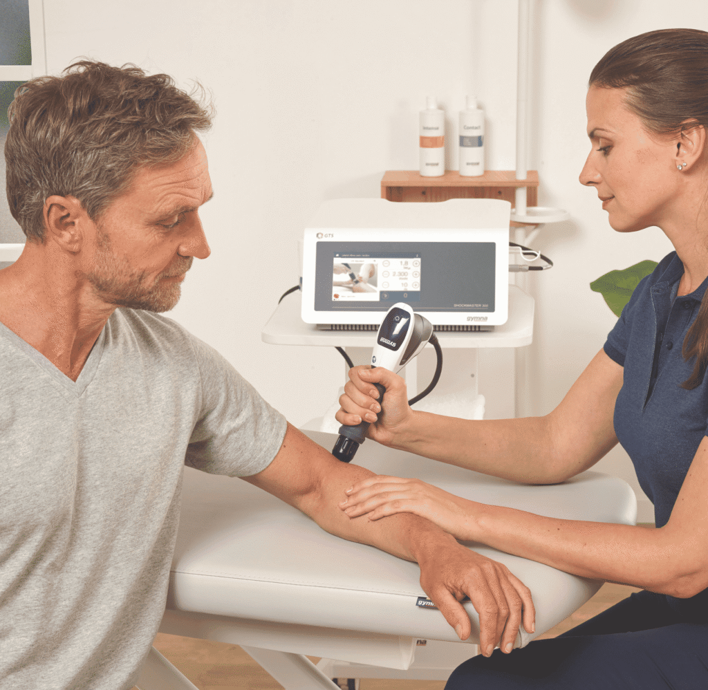 physiotherapist treating a patient with shockwave therapy 